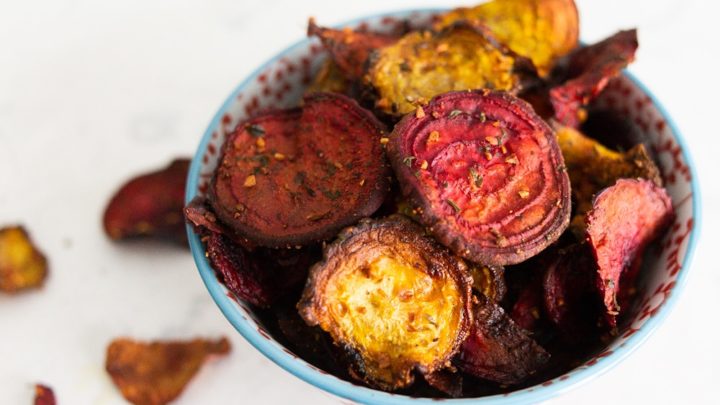 A bowl of golden and purple beets fried to become chips