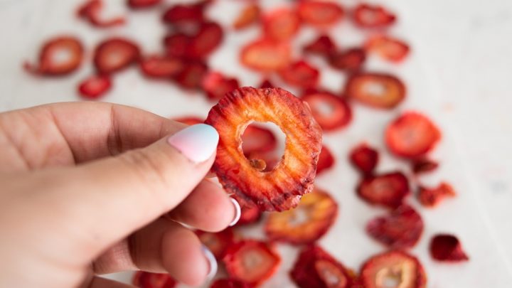 An oven dried strawberry - still bright red but thinner than an average slice of strawberry.